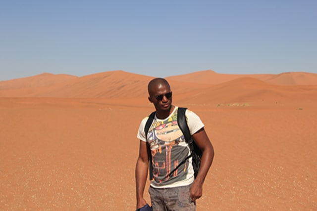 A photo of Alain Dimanche on a desert