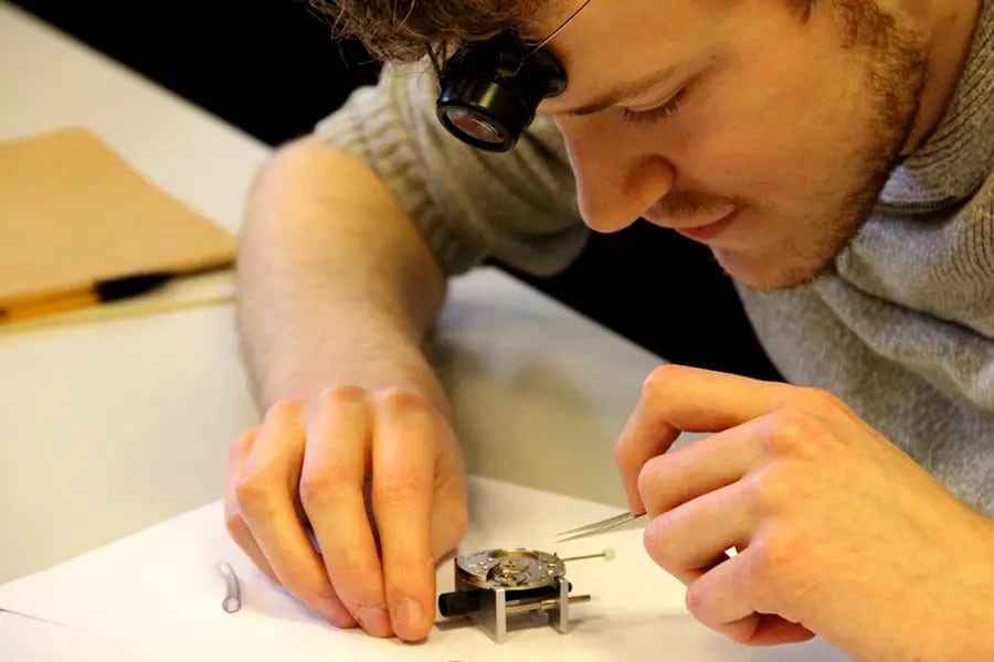 A man assembling a watch