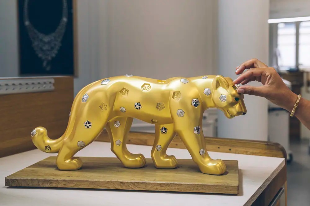 A sculpture of a panther encrusted with gemstones