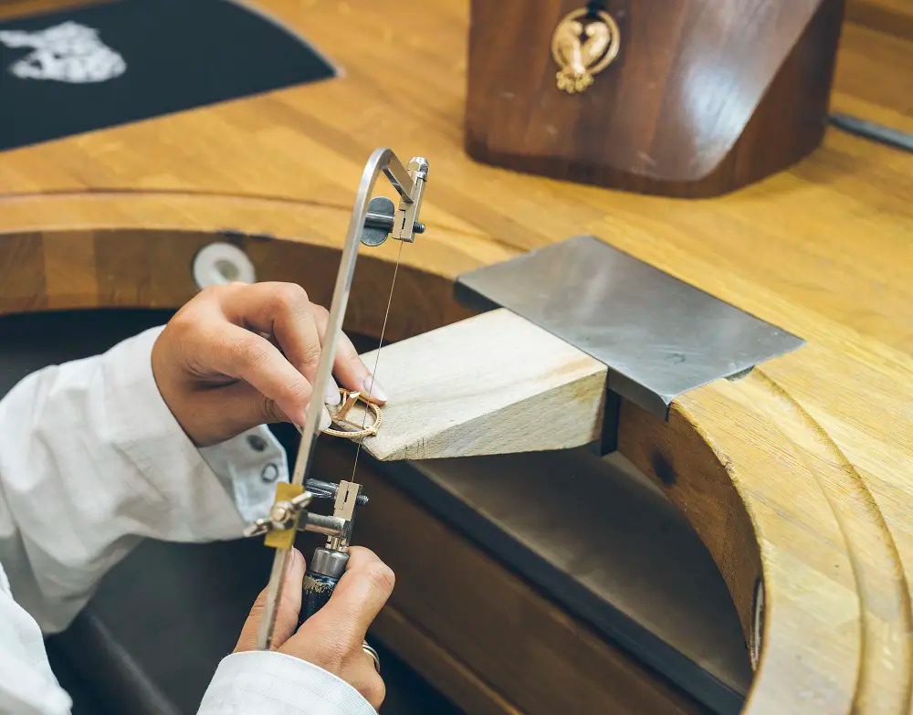 A person working on a jewellery piece in a workshop