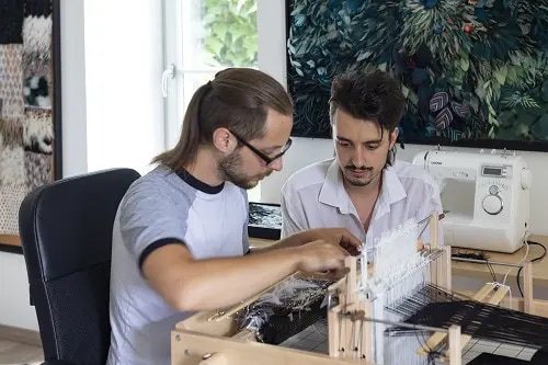 A man occupied with featherworking