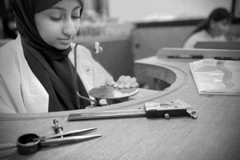 A woman working on a piece of jewellery in a workshop