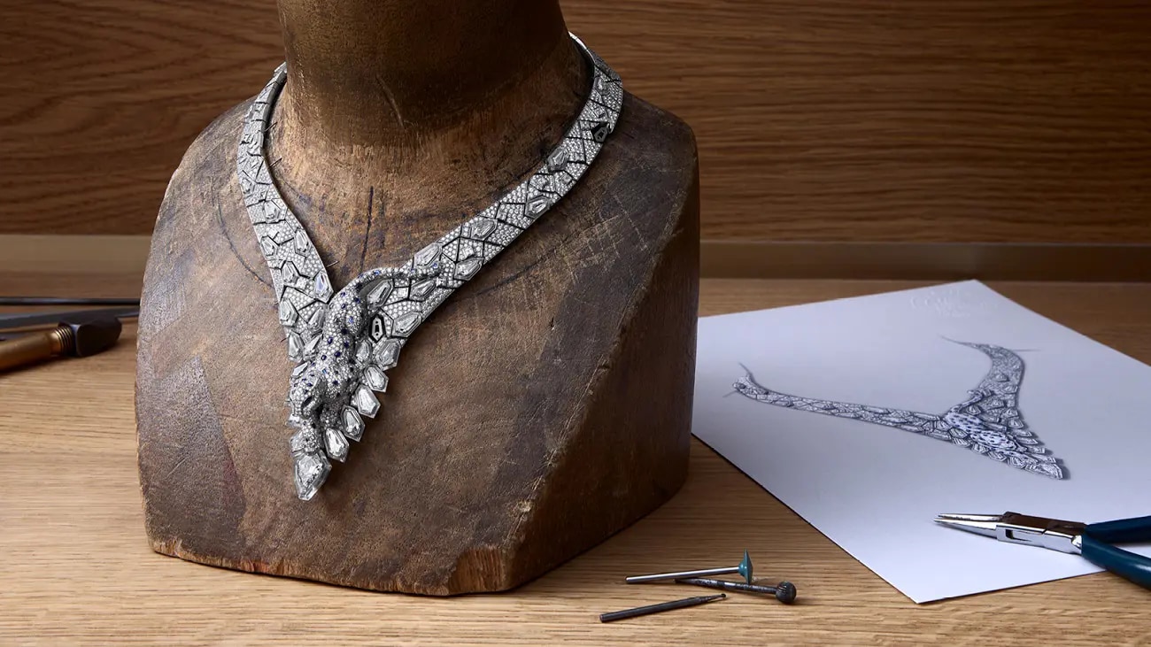 A necklace with a panther and a sketch in a workshop
