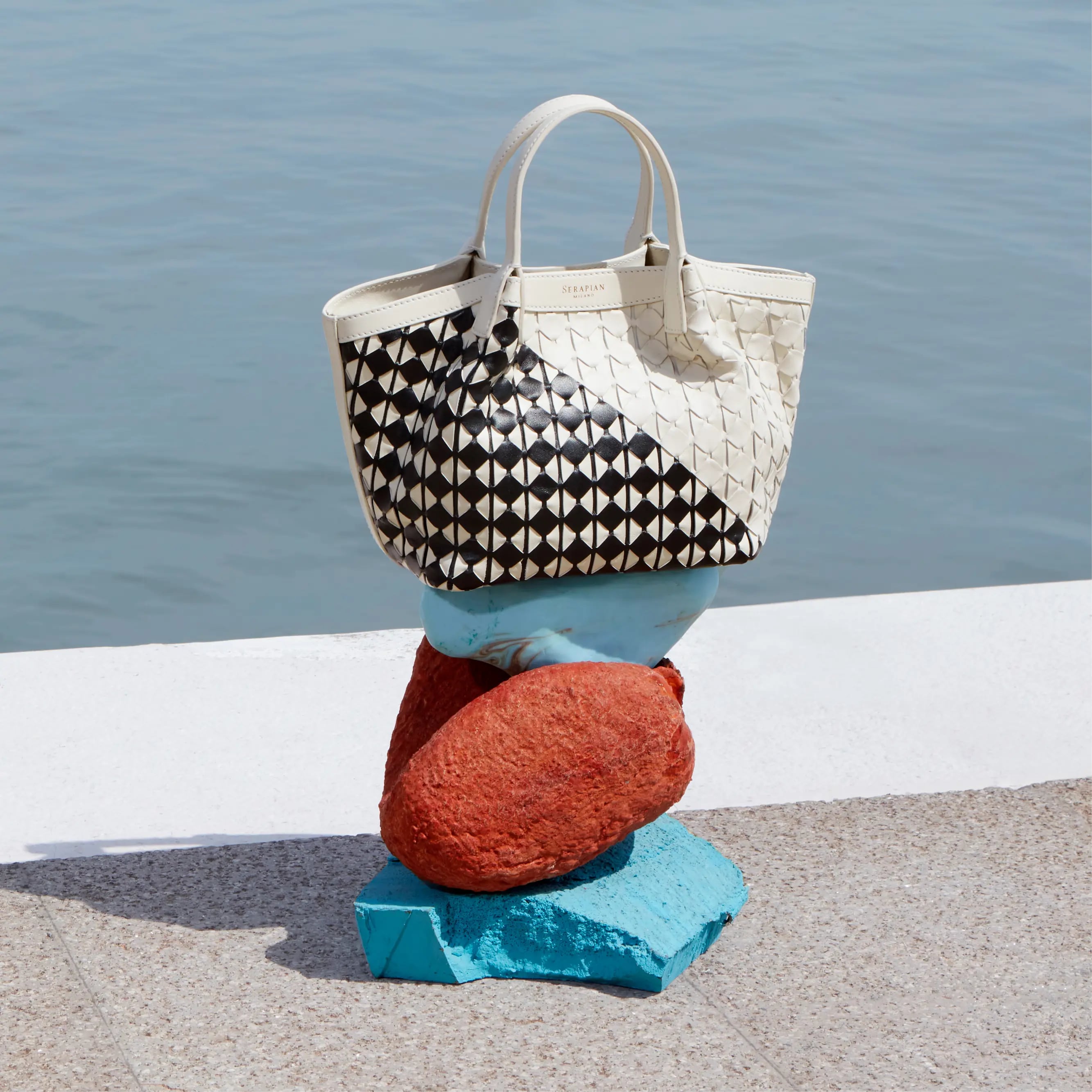 Serapian black and white Mosaic bag on blue and red pyramid of stones