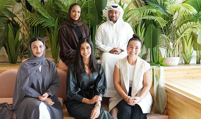 A group photo of four women and a man