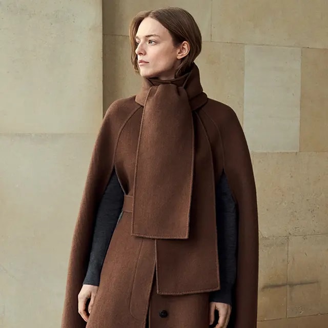 A woman wearing a brown coat