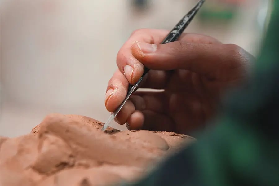 A close up of a person working with clay