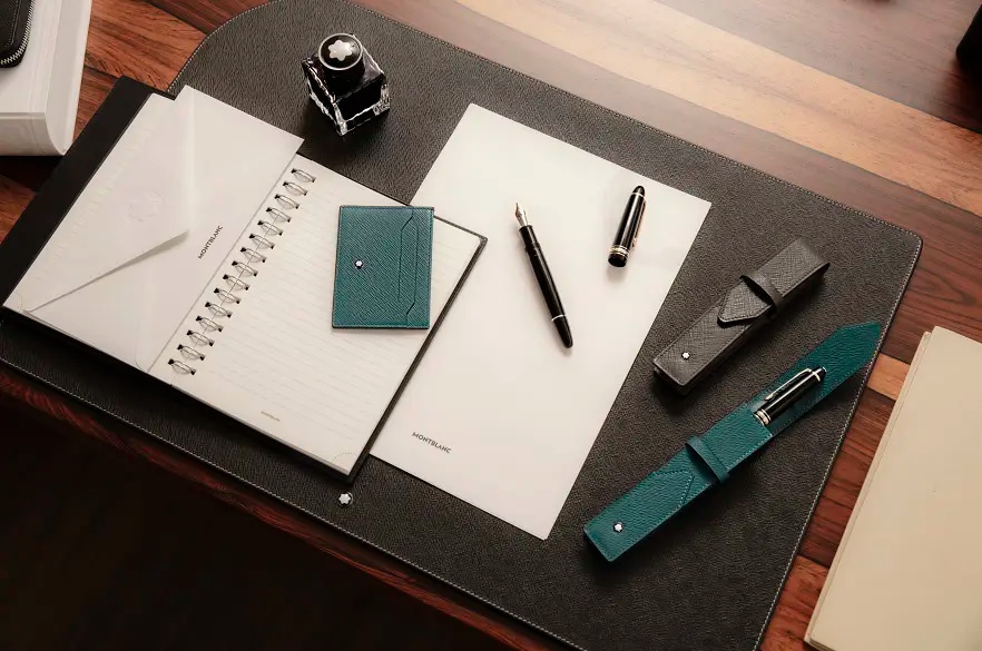 A view of a desk with paper and writing accessories by Montblanc