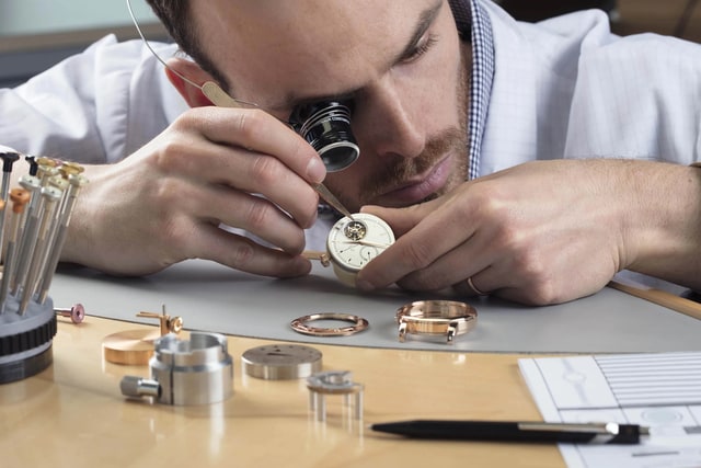 A man assembling a watch