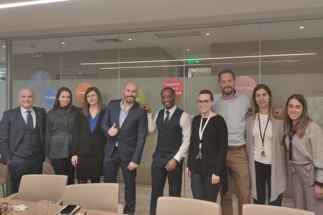 A photo of group of people in an office