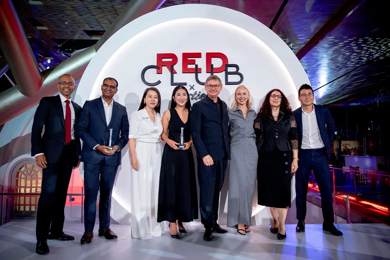 A group of people on stage with an award